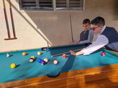 Boys playing billiards