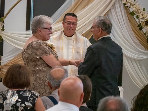 Joe placing a ring on Leonilda's finger